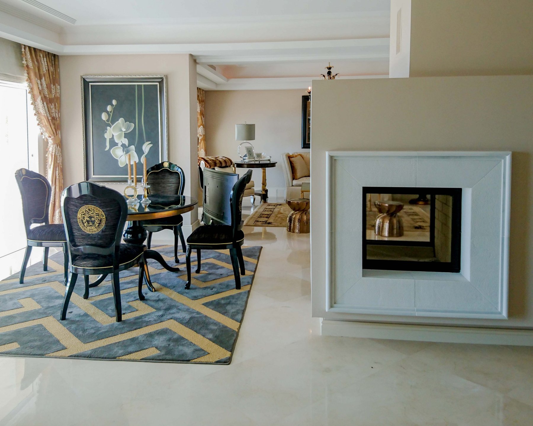 Elegant dining area with statement fireplace and marble floor