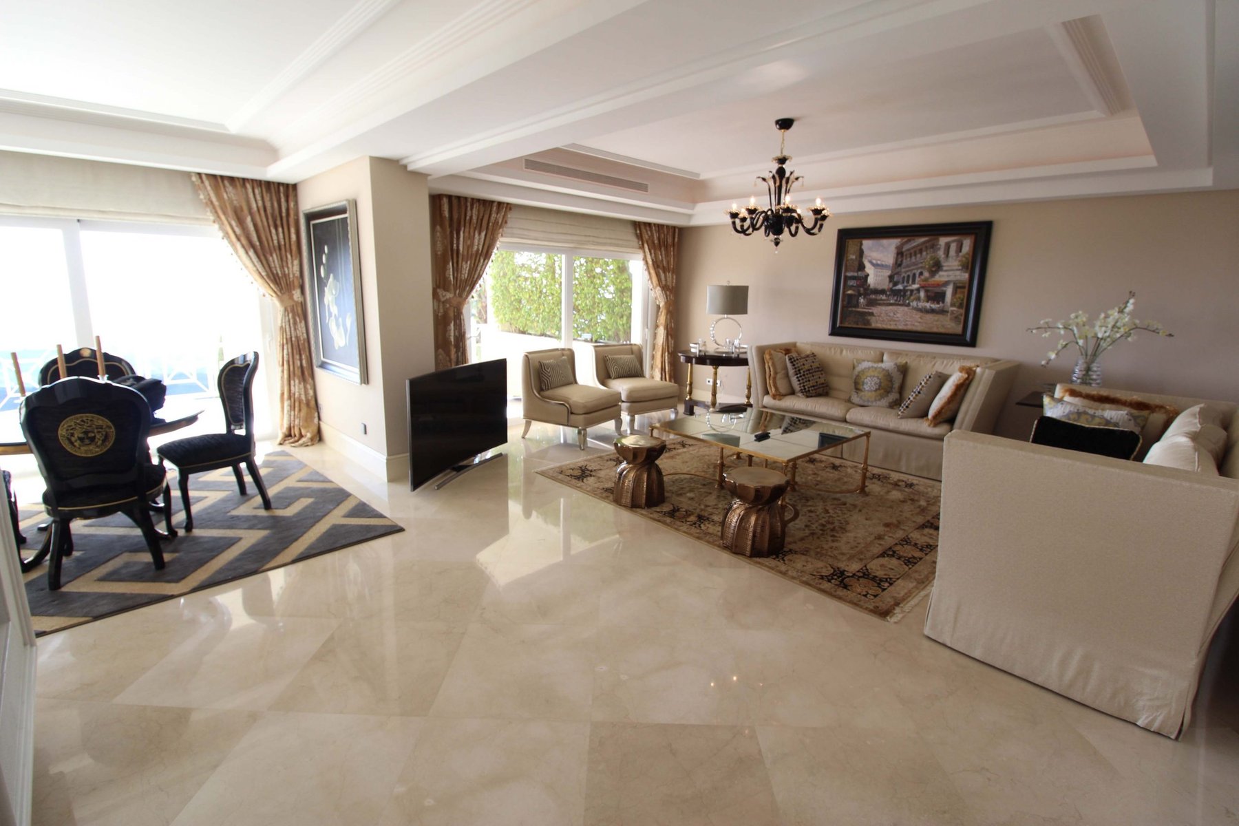 Elegant living and dining room with marble flooring